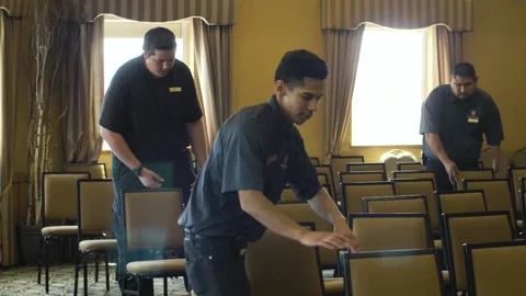Long track as 4 men are fixing chairs Stock Footage 136952885