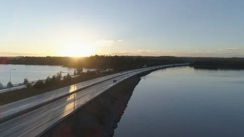 Long Tracking Shot of a Car Crossing the Lake via Strait and Bridge Video stock 85975981