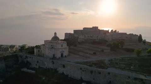 Long tracking shot of Milazzo castle at sunset, Sicily - 4K 60 FPS Aerial drone Stock Footage 201545974