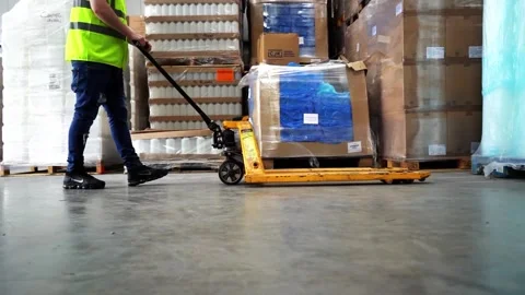 Long Tracking Shot Of Worker Using Pallet Truck Stock Footage 156499279