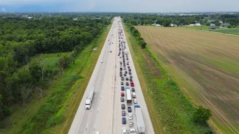 Long traffic jam stretches along I75 freeway through rural Michigan countryside Stock Footage 311055239