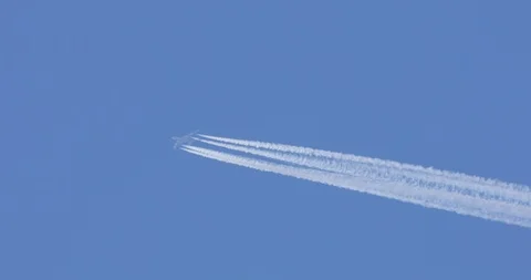 A long trail of jet plane on blue sky - passenger airliner Video stock 105300945