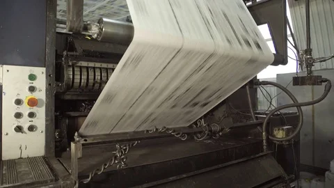 Long uncut paper on rolling machine in printing house Stock Footage 71559001
