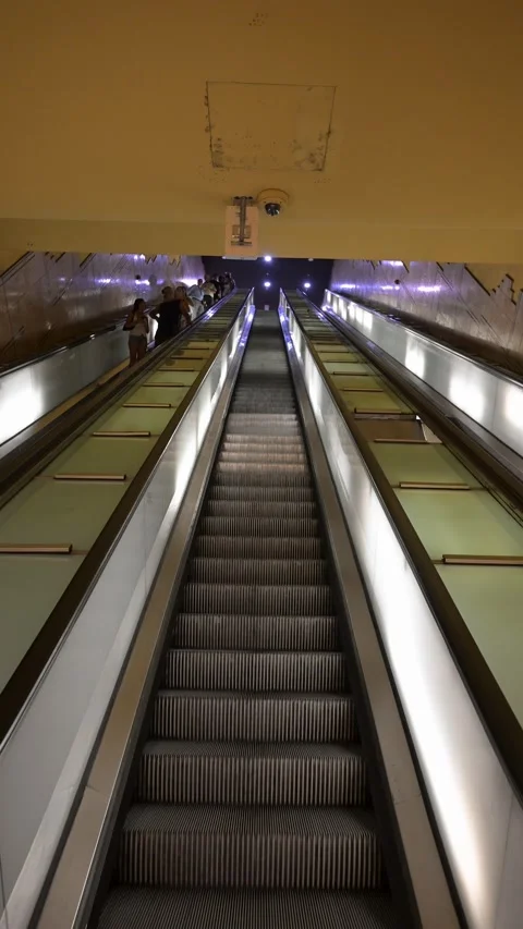 Long Underground Escalator With Commuters in Italian Metro Station Stock Footage 345318451