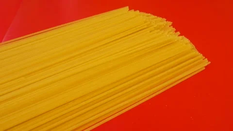 Long vermicelli, spaghetti on red background. Stock Footage 257668089