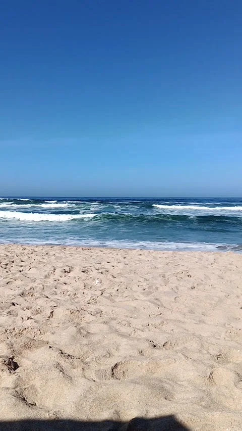 Long vertical video of the sea on the beach sand Stock Footage 233382887