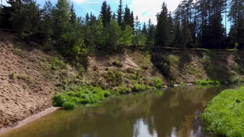 Long video flying around a u-turn of a small river with high sandy banks Stock Footage 169930087