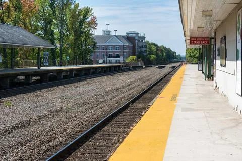 Long view of train station with tracks and platform Stock Photos
