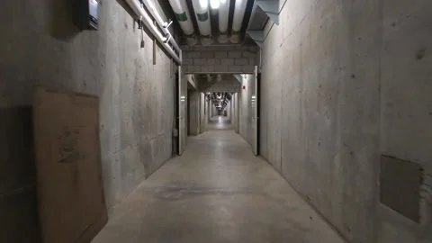 Long walk down concrete tunnel Video stock 175395790