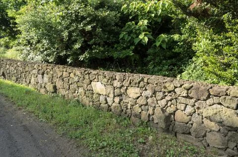 The long wall made by gray mountain stone. Stock Photos