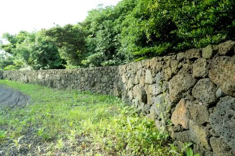 The long wall made by gray mountain stone. Stock Photos