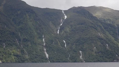 Long Waterfall falling down Mountain at Doubtful Sounds Stock Footage 327764510