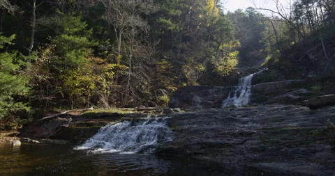 Long waterfall surrounded by colored autumn trees in Kent Falls park Stock Footage 144985537