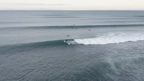 Long waves roll towards shore of Iceland with surfers braving cold water, Stock Footage 144621547