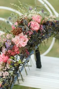 A long wedding bouquet on a frame is on the table Stock Photos