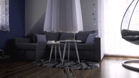 Long wedding dress hanging in tiny room with shoes on the floor Stock Footage 162955007