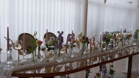 Long Wedding Table Lined with Pink Candles Bud Vases and Spring Flowers 動画素材 344438254