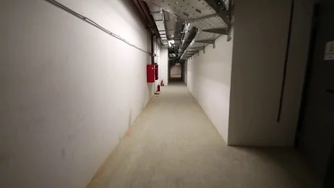 Long white corridor with fire extinguishers in the basement of house Stock-Footage 73727594