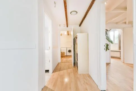 Long white corridor leading with many doors Stock Photos
