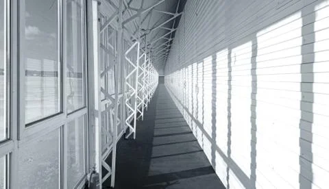 Long white empty corridor interior with metal construction Stock Photos