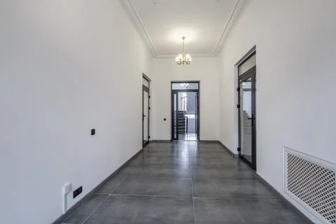 Long white empty corridor in interior of entrance hall of modern apartments,  Stock Photos