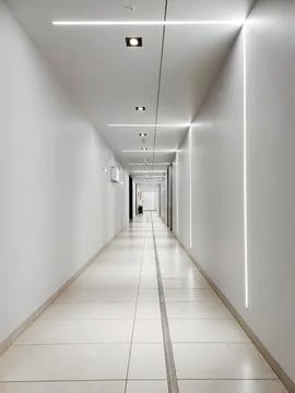 Long white tunnel with LED lighting. Stock Photos