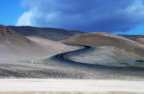 Long winding road through the sandy dunes of Iceland Stock Photos