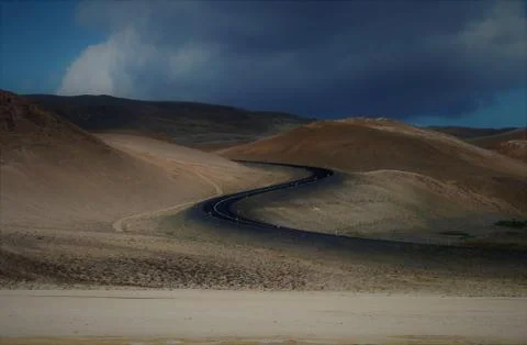 Long winding road through the sandy dunes of Iceland Stock Photos