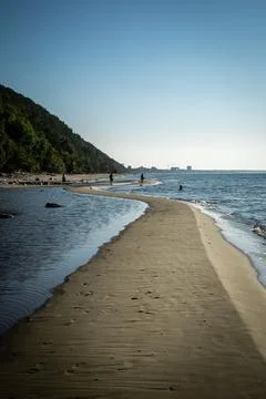 A long winding sand patch along the seaside. Stock Photos