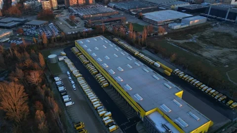 Long yellow DHL distribution center Berlin. Amazing aerial view flight drone Stock Footage 321819793