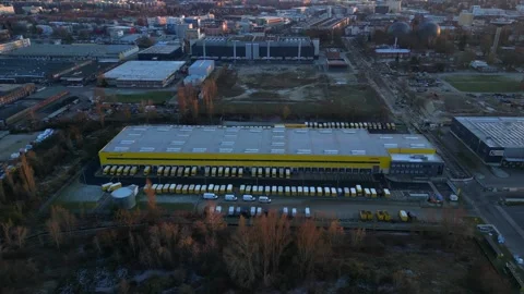 Long yellow DHL distribution center Berlin. Dramatic aerial view flight drone Stock Footage 321821369