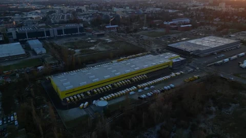 Long yellow DHL German Post distribution center in Berlin. Lovely aerial view Stock Footage 322186929