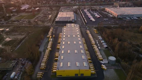Long yellow DHL German Post distribution center in Berlin. Perfect aerial view Stock Footage 322186951