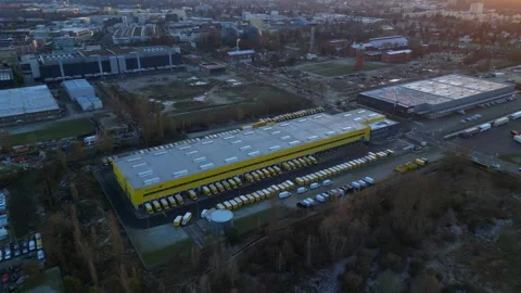 Long yellow DHL German Post distribution center in Berlin. Smooth aerial view Stock Footage 322186979