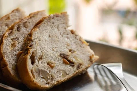 Longan and walnut bread slices by the window in the sunlight. Stock Photos