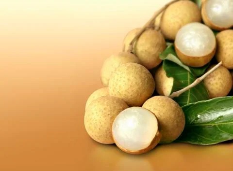 Longan on orange solid background Stock Photos