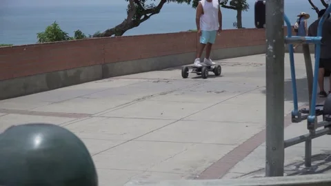Longboard guy next to a exercising machine moving by itself Video stock 172424488