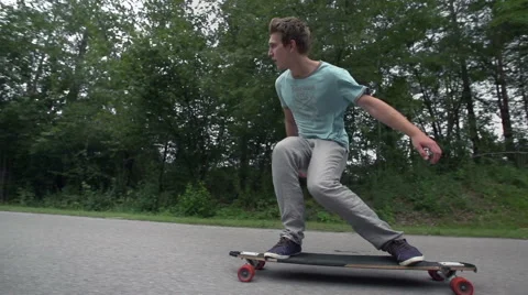Longboard skating low angle wide slow motion Stock Footage 42717401