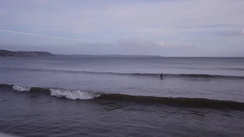 Longboarder takes a wave Stock Footage 82702226