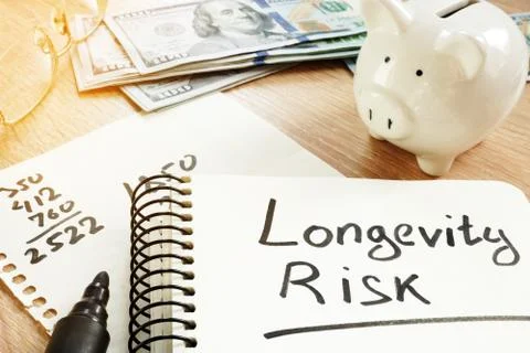 Longevity risk handwritten on a note. Pension concept. Stock Photos