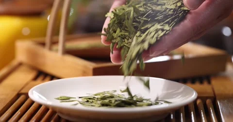 Longjing Tea Leaves Unfolding During Brewing 4K Slow Motion Stock Footage 346472025
