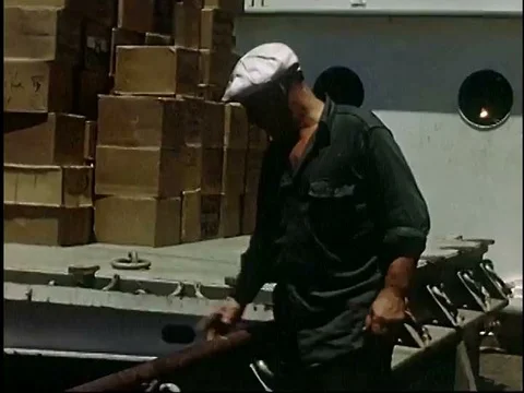 Longshoremen work hard loading the cargo to be lifted on ships in the 1950s. Video stock 75300638