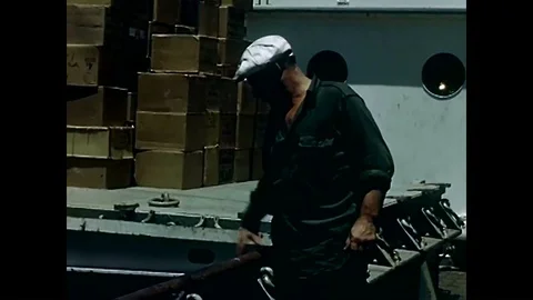 Longshoremen work hard loading the cargo to be lifted on ships in the 1950s. Video stock 88552905