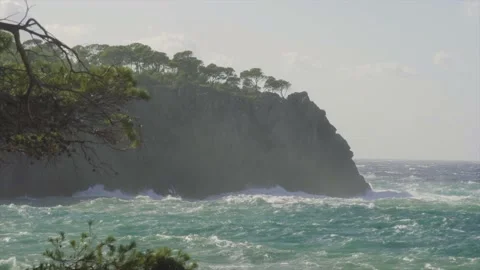 Longshot of coast being battered by rough sea Stock Footage 168774248