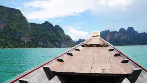 Longtail boat cruising to limestone karst mountains in Khao Sok, Thailand Stock Footage 345293471
