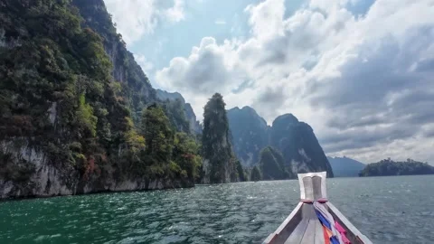 Longtail Boat Passing Karst Cliffs with Boats Nearby Stock Footage 329073166