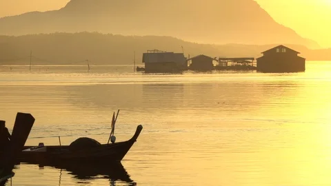 A longtail boat in sunset passing along the coast in southern Thailand. Stock Footage 102019808