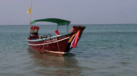 Longtailtaxiboat waiting on the beach Stock Footage 40642985