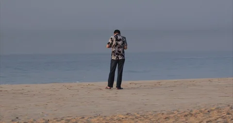 Lonley man on ocean beach Stock Footage 87001979
