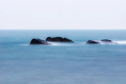 Lonley rocks in ocean Stock Photos